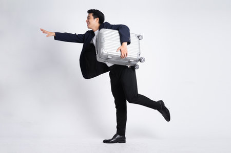 Young business man wearing a suit posing on a white backgroundの写真素材