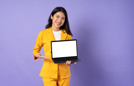 portrait of young businesswoman on purple backgroundの写真素材