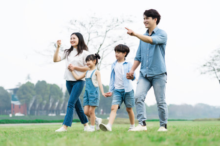 Asian family photo walking together in the parkの写真素材