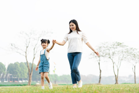 image of mother and daughter playing in the parkの写真素材