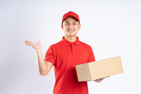 portrait of asian delivery man on white backgroundの写真素材