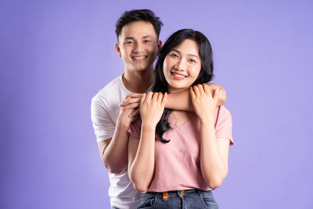 image of asian couple posing on purple backgroundの写真素材