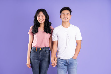 image of asian couple posing on purple backgroundの写真素材