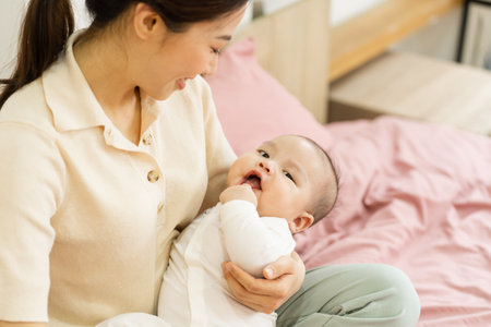 Asian mother and newborn baby feet are smiling and happy