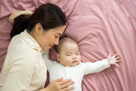 Asian mother and newborn baby feet are smiling and happy