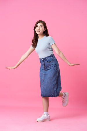 image of asian girl posing on pink backgroundの写真素材