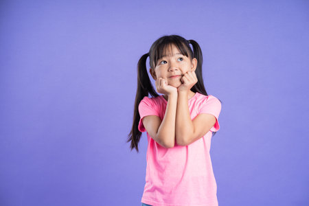 beautiful asian girl portrait posing on purple backgroundの写真素材