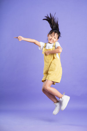 cute asian baby girl posing on purple backgroundの写真素材