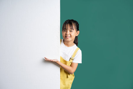 beautiful asian girl posing on blue backgroundの写真素材