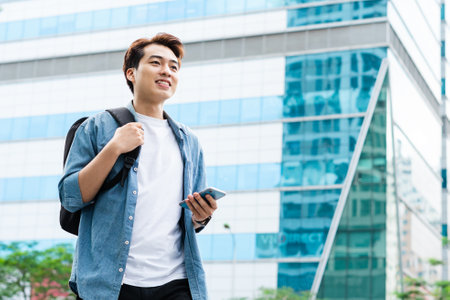 Asian man walking on the streetの写真素材