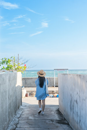 image of a girl and a clear blue beachの写真素材
