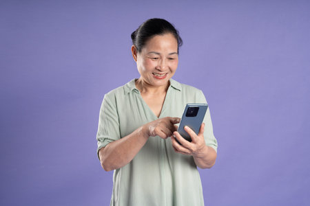 Gangang middle-aged Asian female portrait posing on purple background