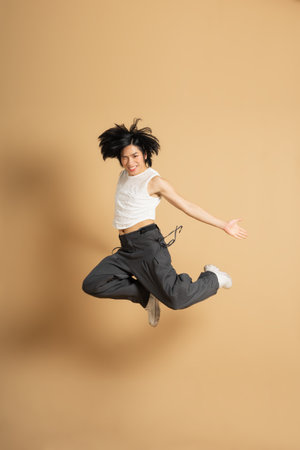 Image of Asian dancer dancing on beige background