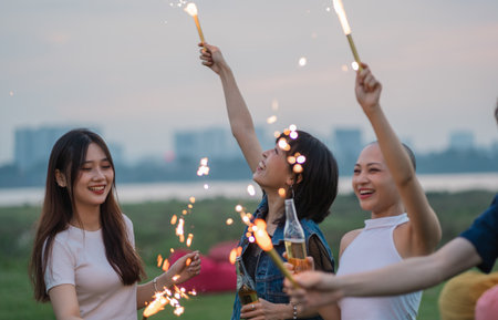 Image of group of friends celebrating and drinking beer togetherの写真素材
