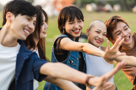 Image of a group of young Asian people laughing happily togetherの写真素材