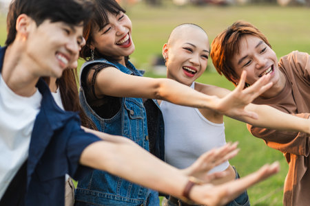 Image of a group of young Asian people laughing happily togetherの写真素材