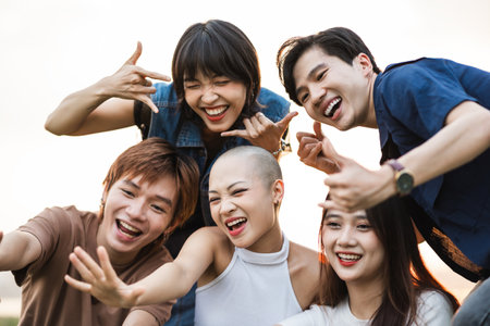 Image of a group of young Asian people laughing happily togetherの写真素材