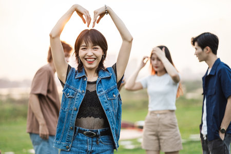 Image of a group of young Asian people laughing happily togetherの写真素材