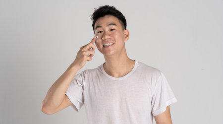 Portrait of Asian man posing on white backgroundの写真素材