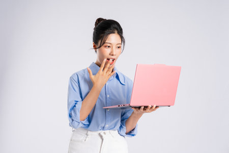 Portrait of young Asian businesswoman, isolated on white backgroundの写真素材