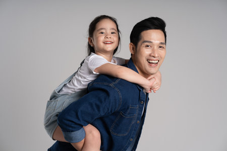 Portrait of father and daughter posing on white backgroundの写真素材