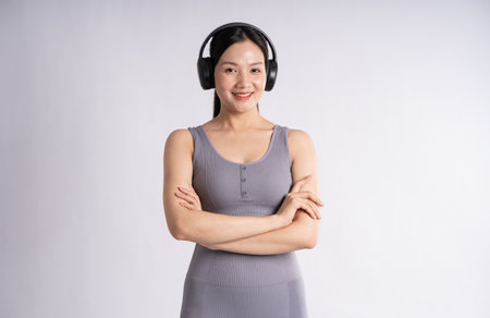 Portrait of Asian woman wearing sportswear, posing on white backgroundの写真素材