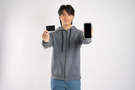 Portrait of asian man wearing hoodie posing on white background
