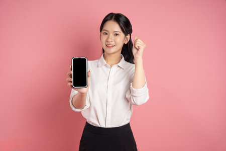 portrait of Asian business woman posing on pink background