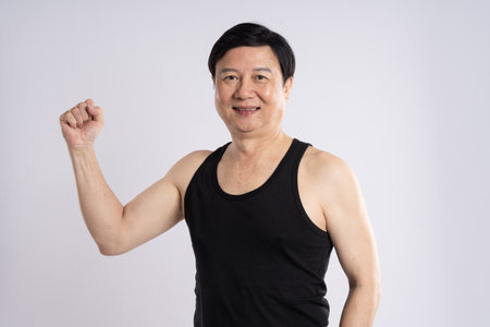 portrait of elderly man exercising on white background