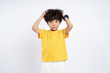 Portrait of beautiful Asian boy posing on white background, childの写真素材