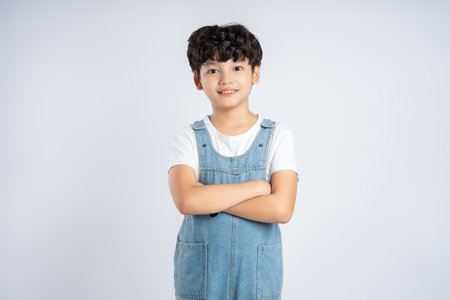 Portrait of beautiful Asian boy posing on white background, child