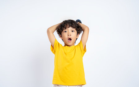 Portrait of beautiful Asian boy posing on white background, childの写真素材