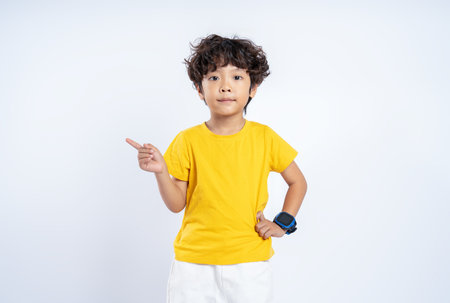 Portrait of beautiful Asian boy posing on white background, child