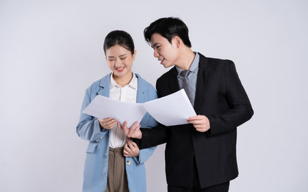 Image of an Asian business couple posing on a white background