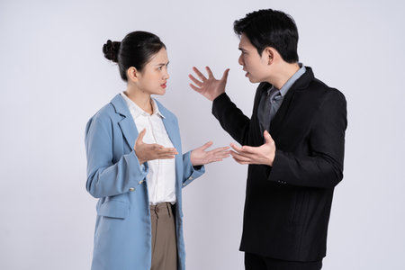 Image of an Asian business couple posing on a white background