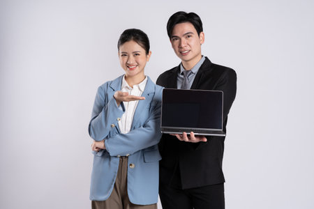 Image of an Asian business couple posing on a white background