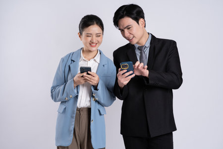 Image of an Asian business couple posing on a white backgroundの写真素材