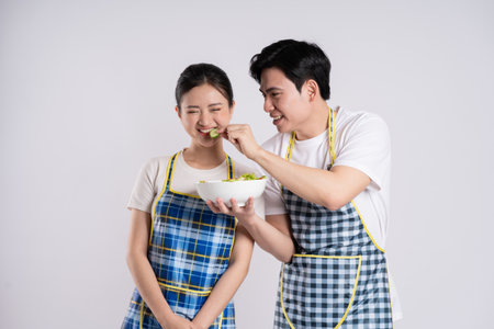 Image of Asian couple posing on white backgroundの写真素材