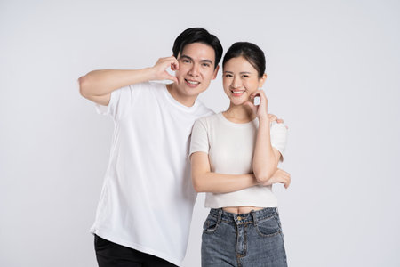 Image of Asian couple posing on white background