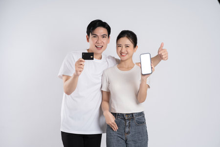 Image of Asian couple posing on white backgroundの写真素材
