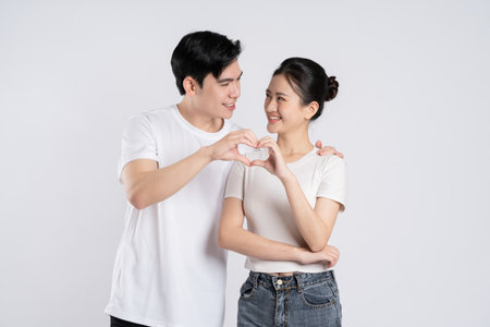 Image of Asian couple posing on white backgroundの写真素材