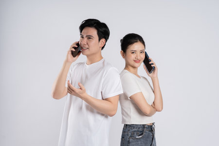 Image of Asian couple posing on white backgroundの写真素材
