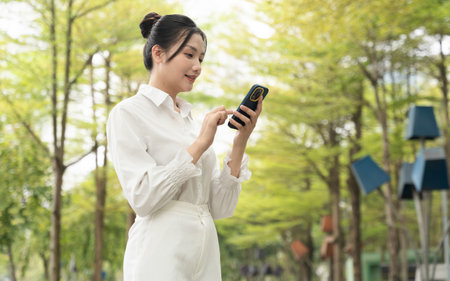 Portrait of young Asian businesswoman in the parkの写真素材