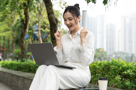 Portrait of young Asian businesswoman in the parkの写真素材