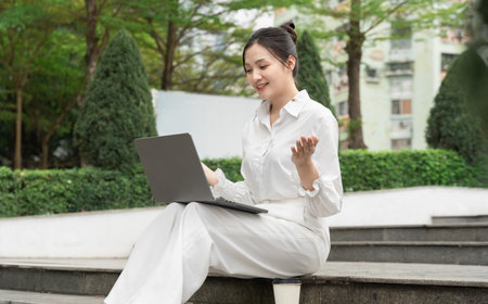Portrait of young Asian businesswoman in the parkの写真素材