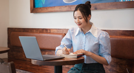 Portrait of Asian woman working at a coffee shopの写真素材