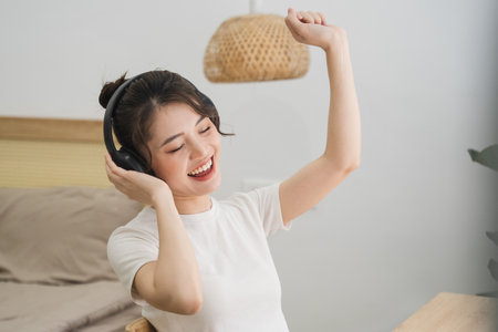 Portrait of beautiful young Asian girl at homeの写真素材