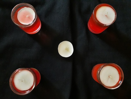 candal in red water glassの写真素材