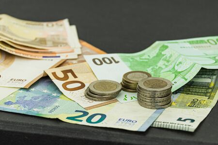 Coins and bills of different values in bird perspectiveの写真素材