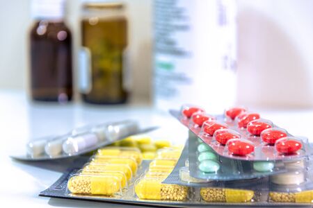Medicine pills of different colors and dimensions on stack, cure for disease and viruses